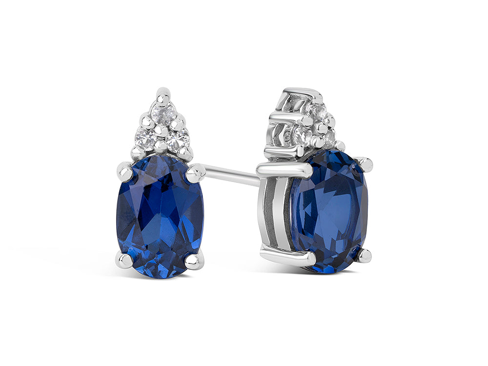 FJC Finejewelers 10k White Gold 7x5mm Oval Created Blue Sapphire with White Topaz Earrings