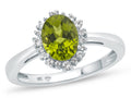 FJC Finejewelers 10k White Gold 8x6mm Oval Peridot with White Topaz accent stones Halo Ring