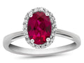 FJC Finejewelers 10k White Gold 7x5mm Oval Created Ruby with White Topaz accent stones Halo Ring