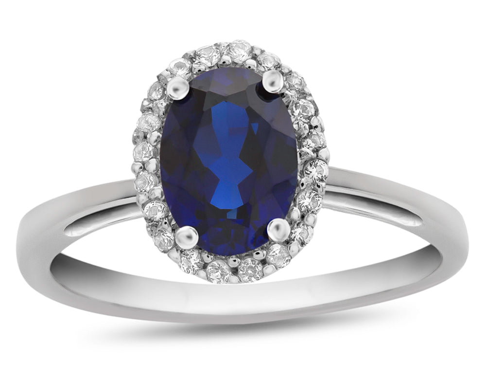 FJC Finejewelers 10k White Gold 7x5mm Oval Created Blue Sapphire with White Topaz accent stones Halo Ring