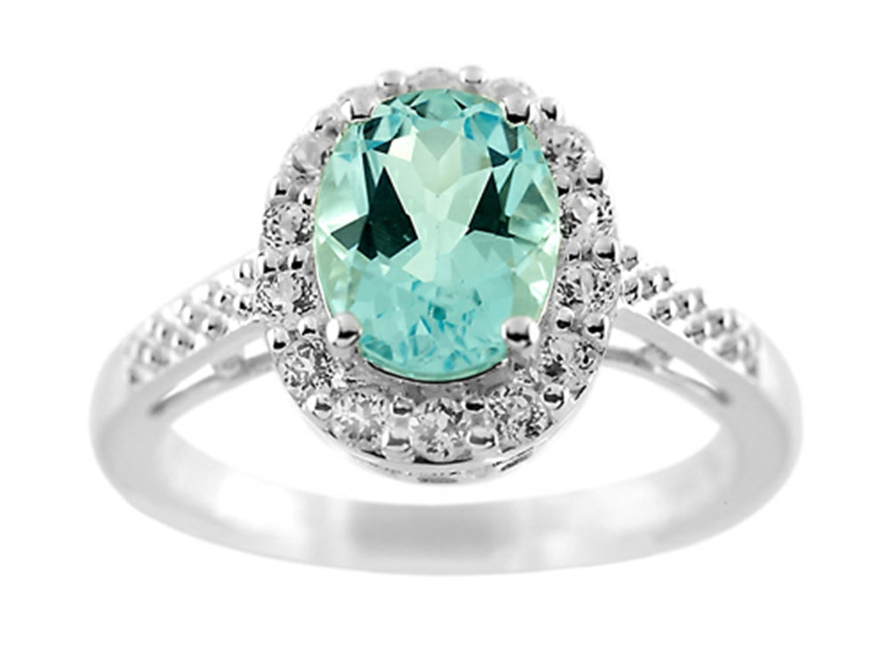 FJC Finejewelers 9x7mm Oval Blue Topaz and White Topaz Halo Ring